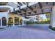 Covered entrance with brick pavers and lush landscaping at 415 L Ambiance Dr # C403, Longboat Key, FL 34228