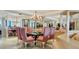 Elegant dining room featuring a glass table and pink chairs at 415 L Ambiance Dr # C403, Longboat Key, FL 34228