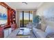 Cozy Gathering room with built-in shelving, comfortable seating, and ocean views at 415 L Ambiance Dr # C403, Longboat Key, FL 34228