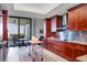 Modern kitchen with wood cabinets, stainless steel appliances, and kitchen island with ocean view at 415 L Ambiance Dr # C403, Longboat Key, FL 34228