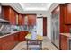Modern kitchen with wood cabinets, stainless steel appliances, and kitchen island at 415 L Ambiance Dr # C403, Longboat Key, FL 34228