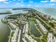 Wide aerial showcasing the community's waterfront location and landscaping at 4360 Chatham Dr # 108, Longboat Key, FL 34228