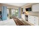Bedroom with built-in desk and view into living area at 4360 Chatham Dr # 108, Longboat Key, FL 34228