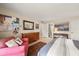 Bedroom with a comfortable chair and view into bathroom at 4360 Chatham Dr # 108, Longboat Key, FL 34228