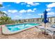 Refreshing community pool with seating area at 4360 Chatham Dr # 108, Longboat Key, FL 34228