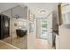 Bright and spacious entryway with mirror and view into living room at 4360 Chatham Dr # 108, Longboat Key, FL 34228