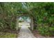 Brick pathway leading through lush foliage at 4360 Chatham Dr # 108, Longboat Key, FL 34228