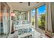 Sunroom with white couch, patterned chairs, and a coffee table with Gathering photos at 4360 Chatham Dr # 108, Longboat Key, FL 34228