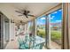 Sunroom with glass sliding doors, water views, and a glass-top dining table at 4360 Chatham Dr # 108, Longboat Key, FL 34228