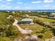 Aerial view of home with playground and waterfront views at 445 Horseshoe Loop Rd, Terra Ceia, FL 34250