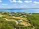 Aerial view of waterfront property with lush landscaping and access to the bay at 445 Horseshoe Loop Rd, Terra Ceia, FL 34250