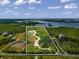 Aerial view of waterfront property with a house and access to the bay at 445 Horseshoe Loop Rd, Terra Ceia, FL 34250