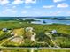 Aerial view of a waterfront property with a pond and surrounding mangroves at 445 Horseshoe Loop Rd, Terra Ceia, FL 34250