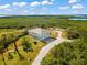 Aerial view of home showcasing waterfront and lush surroundings at 445 Horseshoe Loop Rd, Terra Ceia, FL 34250