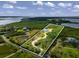 Aerial view of waterfront property with a house and access to the bay at 445 Horseshoe Loop Rd, Terra Ceia, FL 34250