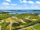 Aerial view of a secluded waterfront lot with pond and mature trees at 445 Horseshoe Loop Rd, Terra Ceia, FL 34250