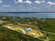 Aerial view of waterfront property with a house and access to the bay at 445 Horseshoe Loop Rd, Terra Ceia, FL 34250