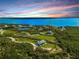 Aerial view of waterfront property with houses and lush greenery at 445 Horseshoe Loop Rd, Terra Ceia, FL 34250