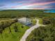 Elevated view of a house with a large yard and surrounding nature at 445 Horseshoe Loop Rd, Terra Ceia, FL 34250