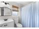 Simple bathroom with a shower/tub combo and striped curtain at 445 Horseshoe Loop Rd, Terra Ceia, FL 34250