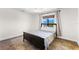 Cozy bedroom featuring wood flooring and a ceiling fan at 445 Horseshoe Loop Rd, Terra Ceia, FL 34250