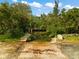 Private boat ramp leading to calm water, nestled among lush greenery at 445 Horseshoe Loop Rd, Terra Ceia, FL 34250
