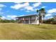 Two-story home with elevated deck and grassy yard at 445 Horseshoe Loop Rd, Terra Ceia, FL 34250