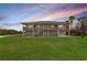 Two-story house exterior, showcasing a spacious lawn and sunset views at 445 Horseshoe Loop Rd, Terra Ceia, FL 34250