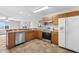 Modern kitchen with stainless steel appliances and wood cabinets at 445 Horseshoe Loop Rd, Terra Ceia, FL 34250
