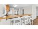 Breakfast bar with seating, wood cabinets and modern flooring at 445 Horseshoe Loop Rd, Terra Ceia, FL 34250