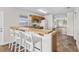 Kitchen features a breakfast bar with seating and wood cabinets at 445 Horseshoe Loop Rd, Terra Ceia, FL 34250
