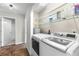 Laundry area with washer, dryer, and storage shelves at 445 Horseshoe Loop Rd, Terra Ceia, FL 34250