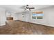 Spacious living room featuring hardwood floors and access to kitchen at 445 Horseshoe Loop Rd, Terra Ceia, FL 34250