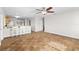 Open living room and kitchen area with wood-look floors at 445 Horseshoe Loop Rd, Terra Ceia, FL 34250
