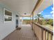 Covered porch with wooden deck, offering scenic views of nature at 445 Horseshoe Loop Rd, Terra Ceia, FL 34250