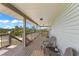 Relaxing covered porch with seating area and nature views at 445 Horseshoe Loop Rd, Terra Ceia, FL 34250