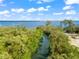 Aerial view of a tranquil waterway, surrounded by lush mangrove trees at 445 Horseshoe Loop Rd, Terra Ceia, FL 34250