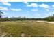 Fenced yard with grassy area and playground equipment at 445 Horseshoe Loop Rd, Terra Ceia, FL 34250