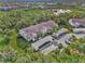 Aerial view of condo building, showing building, parking and landscaping at 4655 Tower Hill Ln # 2412, Sarasota, FL 34238