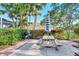 Picnic table with umbrella and grill in a landscaped area at 4655 Tower Hill Ln # 2412, Sarasota, FL 34238