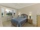 Bright bedroom with a queen bed, bay window, and tiled floor at 4655 Tower Hill Ln # 2412, Sarasota, FL 34238