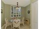 Bright dining area with a glass-top table and wicker chairs at 4655 Tower Hill Ln # 2412, Sarasota, FL 34238