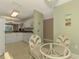 Dining area with a glass-top table and wicker chairs, kitchen view at 4655 Tower Hill Ln # 2412, Sarasota, FL 34238