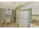Cozy dining area with a glass-top table and wicker chairs, adjacent to the kitchen at 4655 Tower Hill Ln # 2412, Sarasota, FL 34238