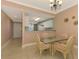 Dining area with glass top table and four chairs at 4655 Tower Hill Ln # 2412, Sarasota, FL 34238