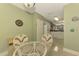 Bright dining area with a glass-top table and wicker chairs, kitchen view at 4655 Tower Hill Ln # 2412, Sarasota, FL 34238