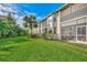 Condo building exterior showcasing a manicured lawn and lush landscaping at 4655 Tower Hill Ln # 2412, Sarasota, FL 34238