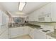Modern kitchen with granite countertops, white cabinets, and stainless steel appliances at 4655 Tower Hill Ln # 2412, Sarasota, FL 34238