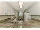 Kitchen boasting granite countertops and white cabinetry, open to dining area at 4655 Tower Hill Ln # 2412, Sarasota, FL 34238