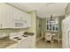 Eat-in kitchen with granite countertops, white cabinets, and a breakfast nook at 4655 Tower Hill Ln # 2412, Sarasota, FL 34238